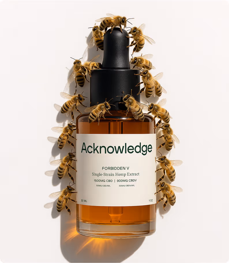 Amber glass dropper bottle of Acknowledge hemp extract surrounded by bees, emphasizing natural and organic product qualities.