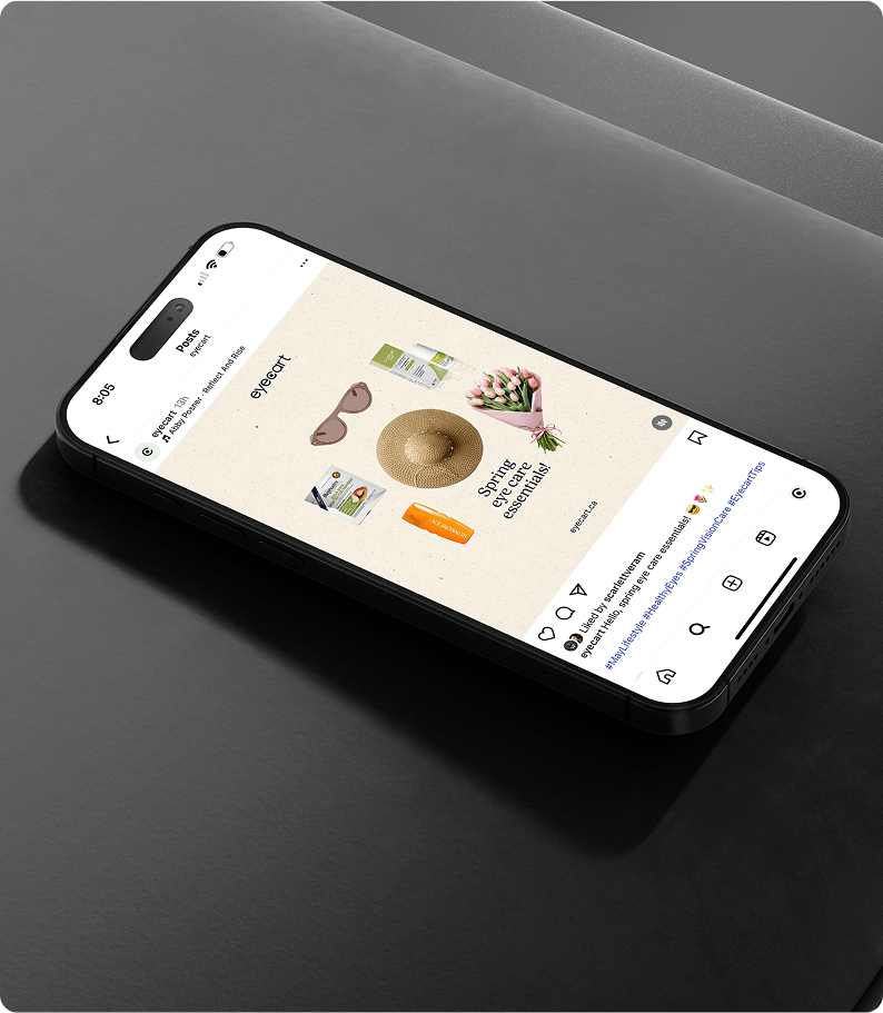 smartphone screen displays an Instagram post from Eyecart featuring a flat lay of spring essentials, including sunglasses, a straw hat, tulips, and wellness products, with the caption “Spring eye care essentials.”