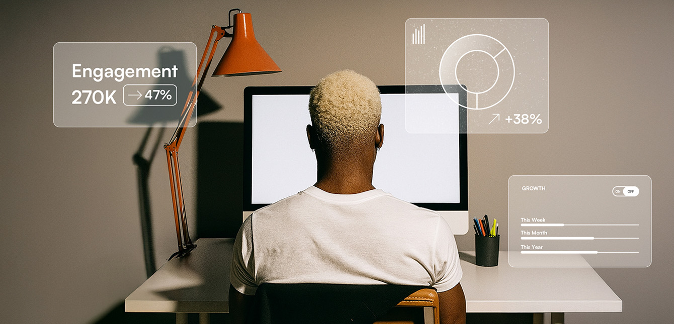 Person with bleached blonde hair sits at a desk facing a computer, surrounded by digital overlays showing engagement, growth, and performance analytics.