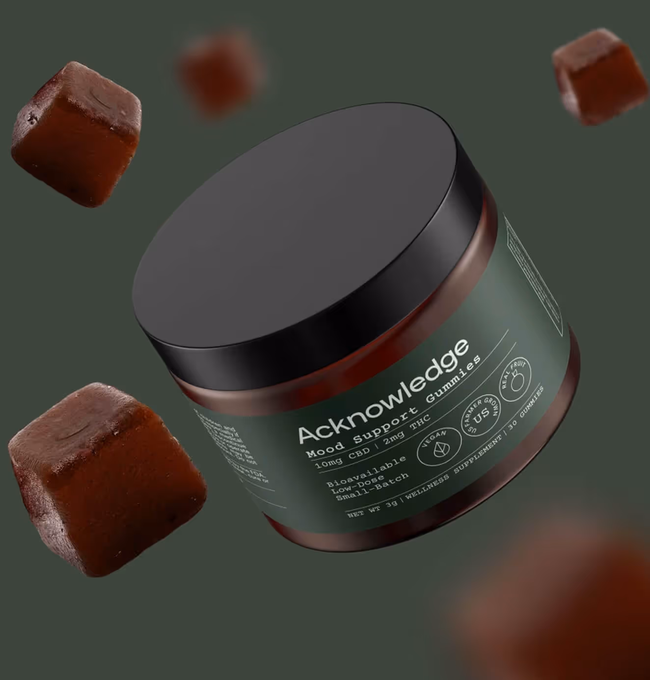 A jar of Acknowledge Mood Support Gummies surrounded by floating chocolate-colored gummy cubes on a dark green background.