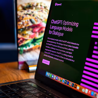 Laptop screen showing ChatGPT’s homepage with text about optimizing language models for dialogue, suggesting AI-driven content creation.