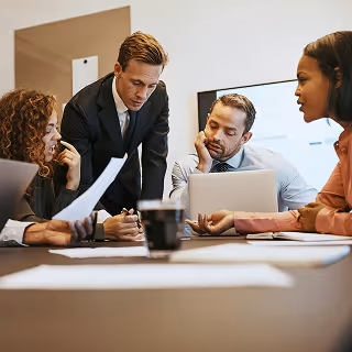 Professional business meeting with a diverse group of people discussing strategy, conveying collaboration and firm management.