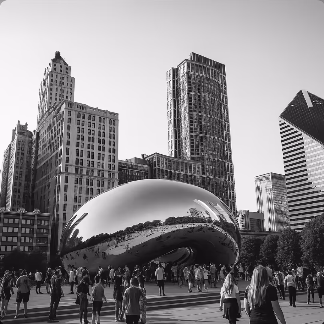 A black-and-white photo of Cloud Gate in Millennium Park with crowds of visitors reflected in the polished steel sculpture.