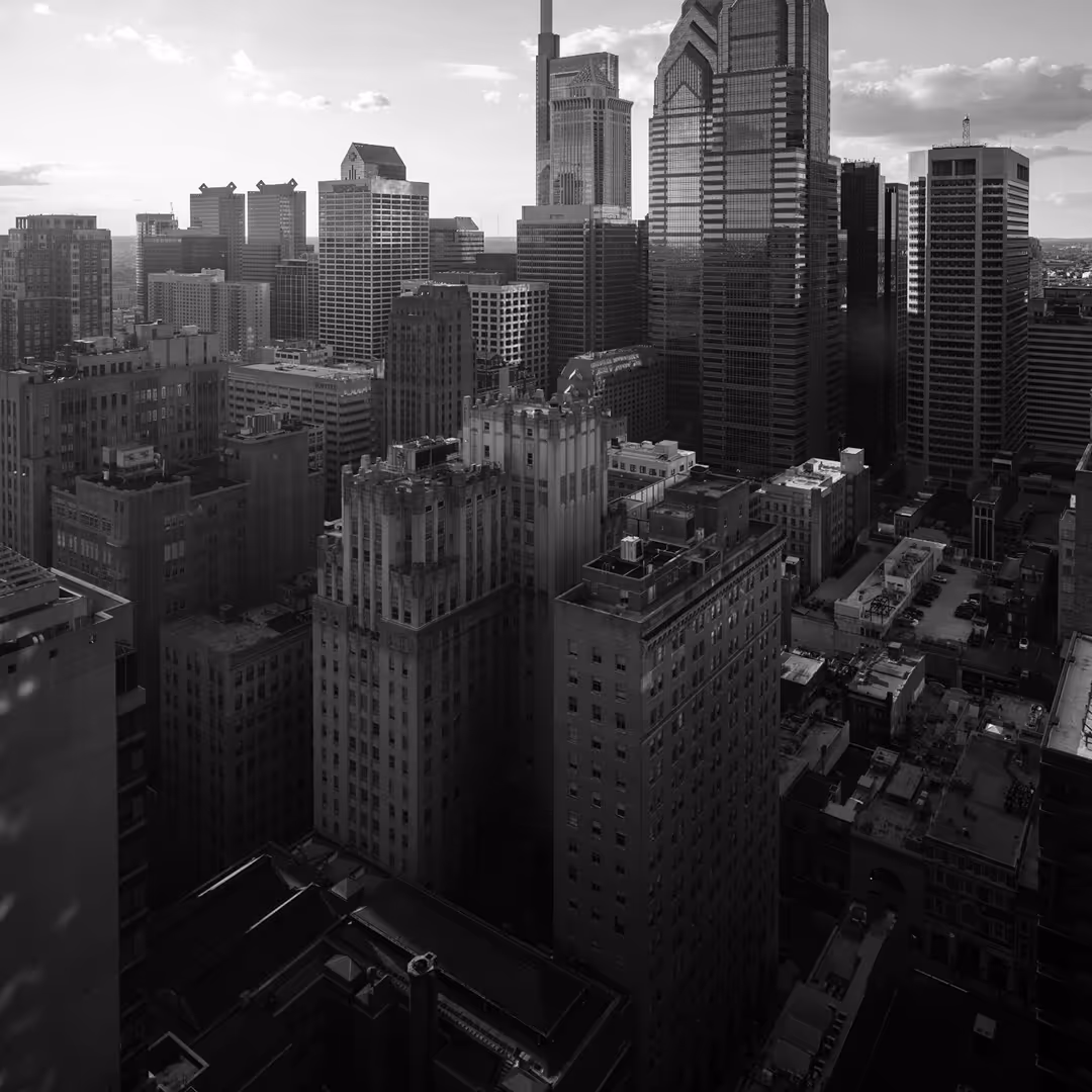 Black and white photo of Philadelphia’s downtown skyline with a mix of modern and historic skyscrapers.