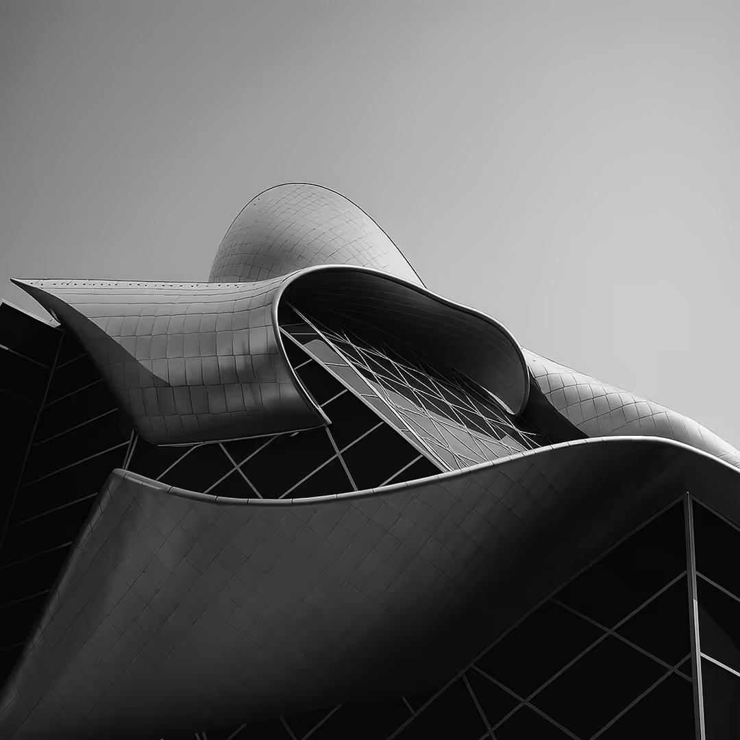 A striking black-and-white image of the Art Gallery of Alberta in Edmonton, showcasing its flowing, futuristic steel and glass architectural design.