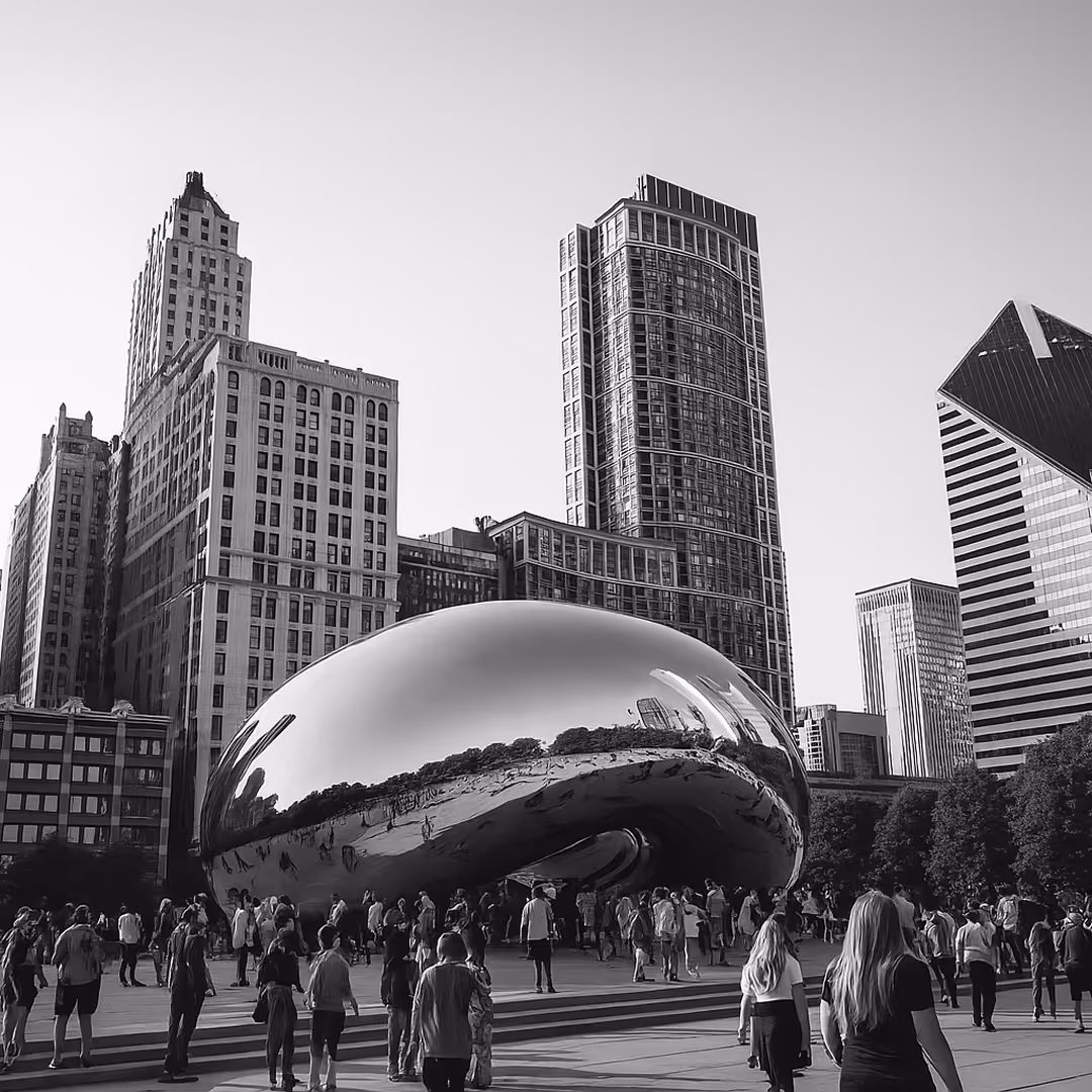 A wider shot of Cloud Gate sculpture with modern skyscrapers in the background and visitors gathered around.