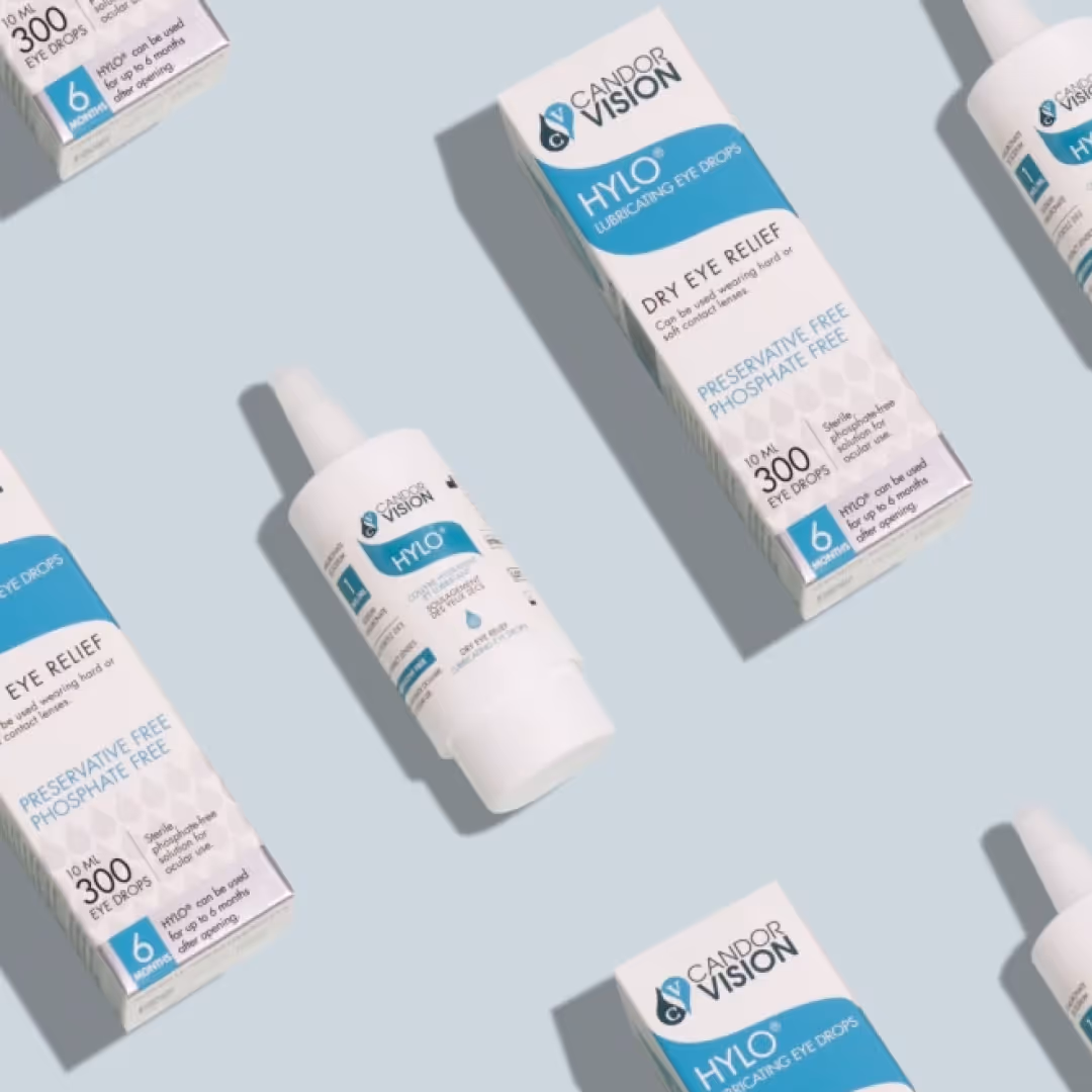 Flat-lay arrangement of HYLO lubricating eye drops packaging by Candor Vision, showing preservative-free dry eye relief branding.