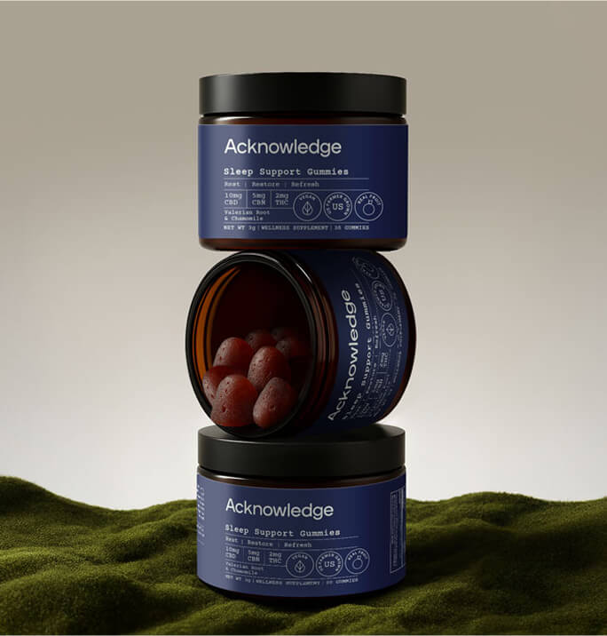 Acknowledge Sleep Support Gummies jars stacked, one open to reveal red gummies. Packaging features deep blue labels.