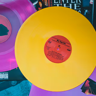 A close-up of a colorful vinyl record collection, with a prominent yellow record on top, symbolizing vintage music appreciation and branding aesthetics.