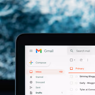 Close-up of a computer screen showing a Gmail inbox with 152 unread messages, emphasizing digital email management.
