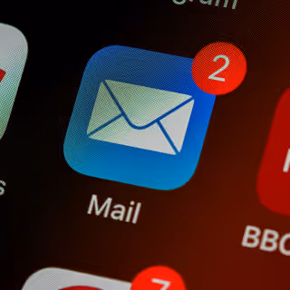 Mobile phone screen showing a mail app with two unread messages, highlighting mobile email notifications.