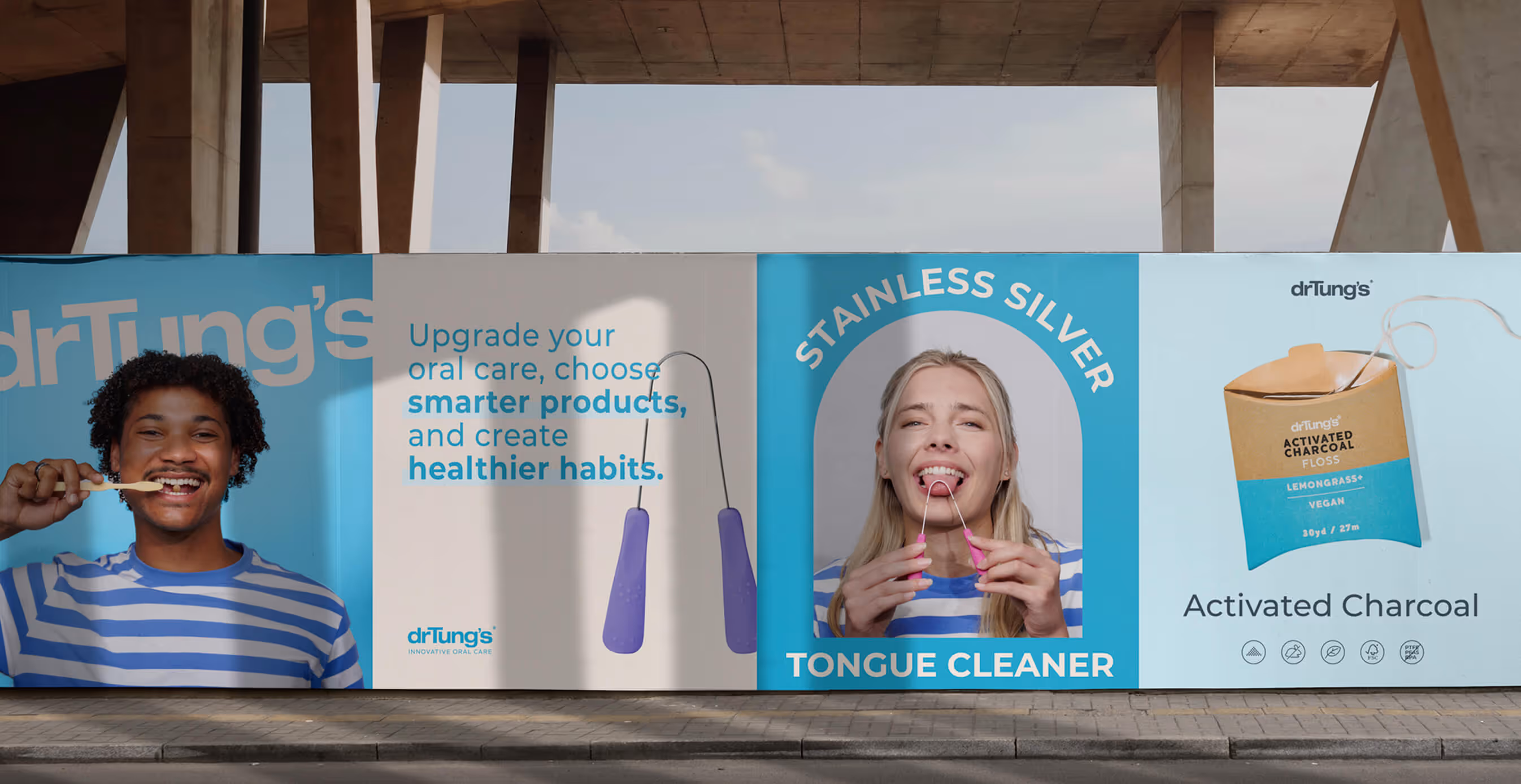 Large outdoor Dr. Tung’s billboard featuring models smiling while brushing teeth and using tongue cleaners, alongside product images and bold health-focused text.