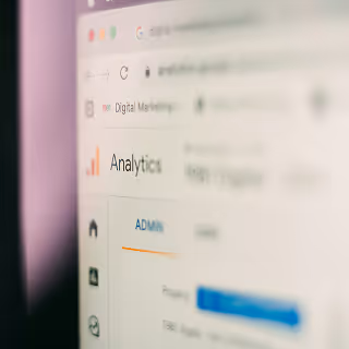 Blurry close-up of a computer screen showing the Google Analytics dashboard with “Digital Marketing” in the browser tab.
