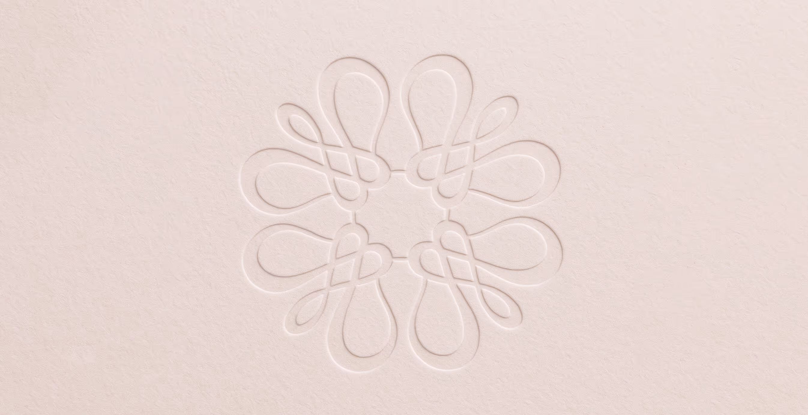Minimalist embossed floral monogram design on soft beige paper, representing Mary Louise Cosmetics’ elegant brand identity.