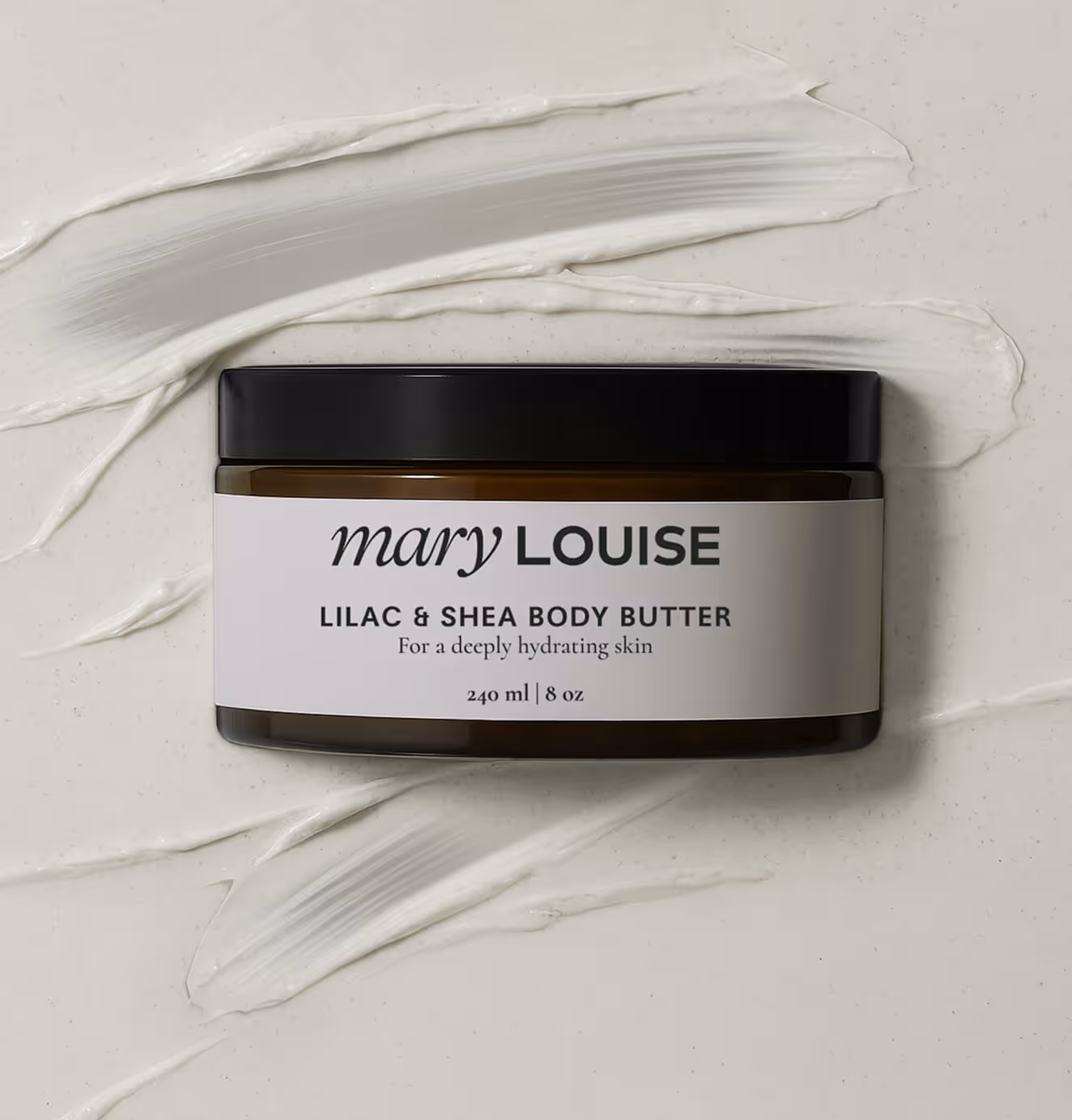 Mary Louise Lilac & Shea Body Butter jar photographed on a flat surface with cream swatches underneath, highlighting hydration and texture.
