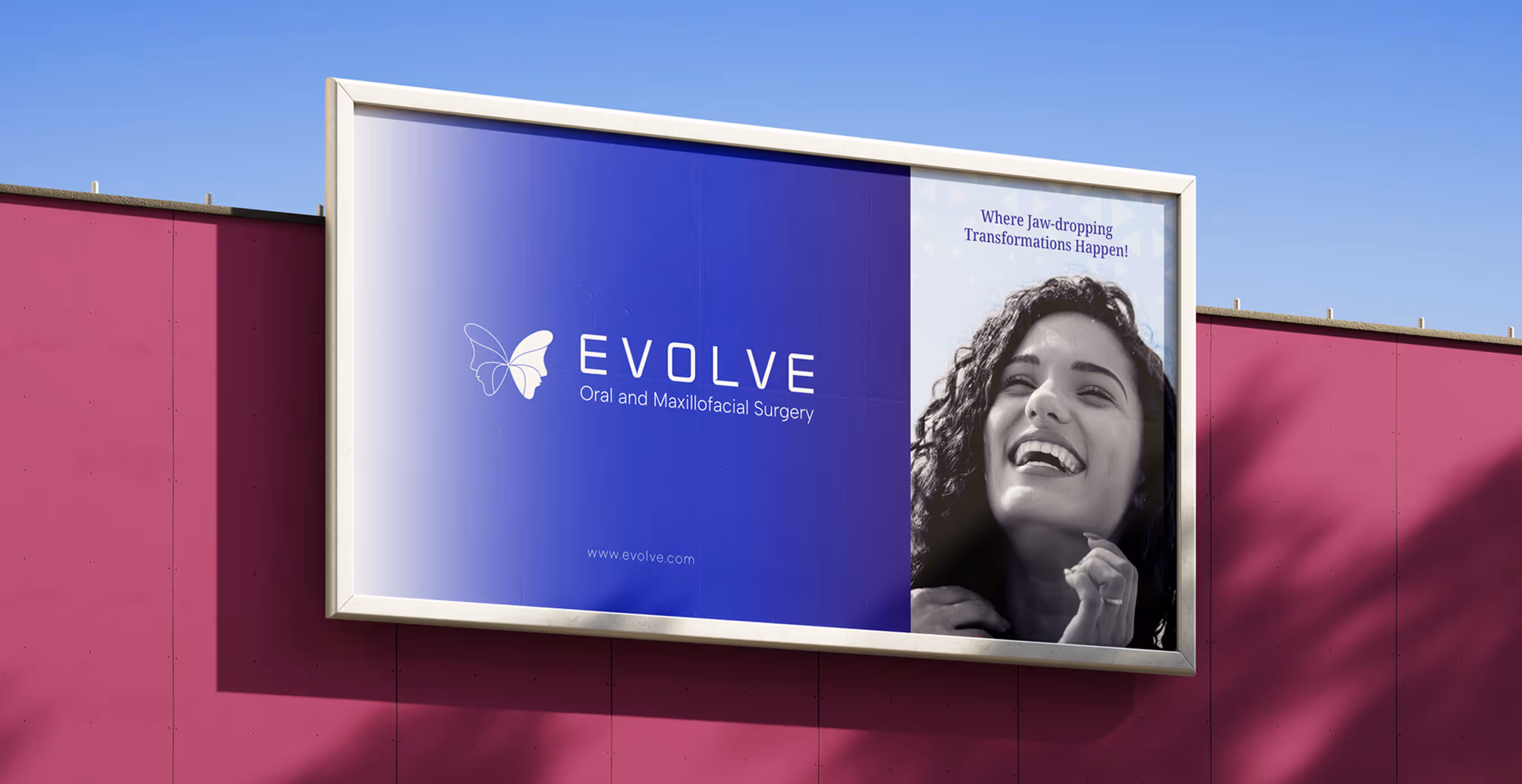 Outdoor billboard featuring the Evolve logo, butterfly icon, and a black-and-white photo of a smiling woman with the tagline “Where Jaw-dropping Transformations Happen!”