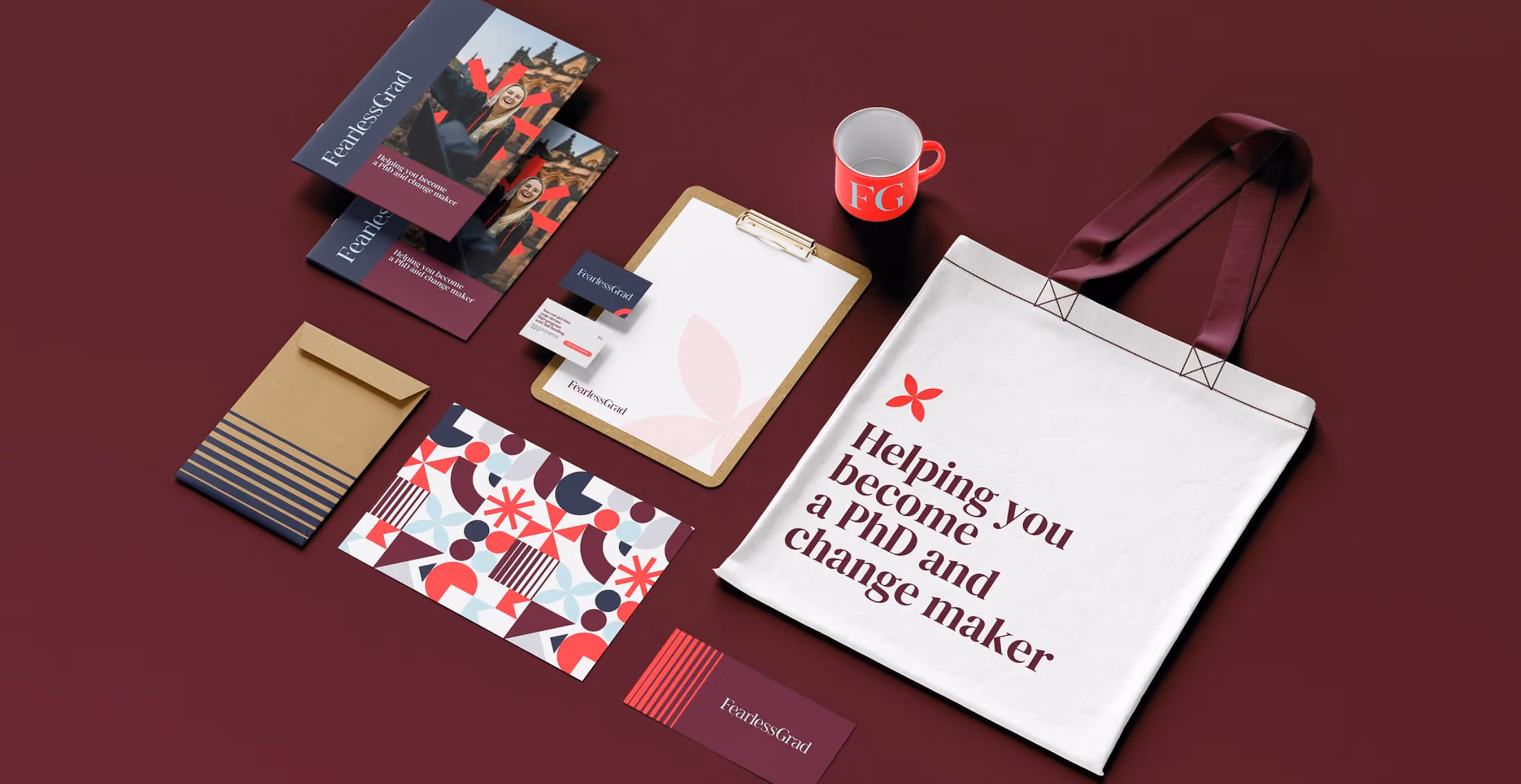 Flat lay of Fearless Grad branded stationery, tote bag, mug, and brochures with bold typography reading “Helping you become a PhD and change maker.”