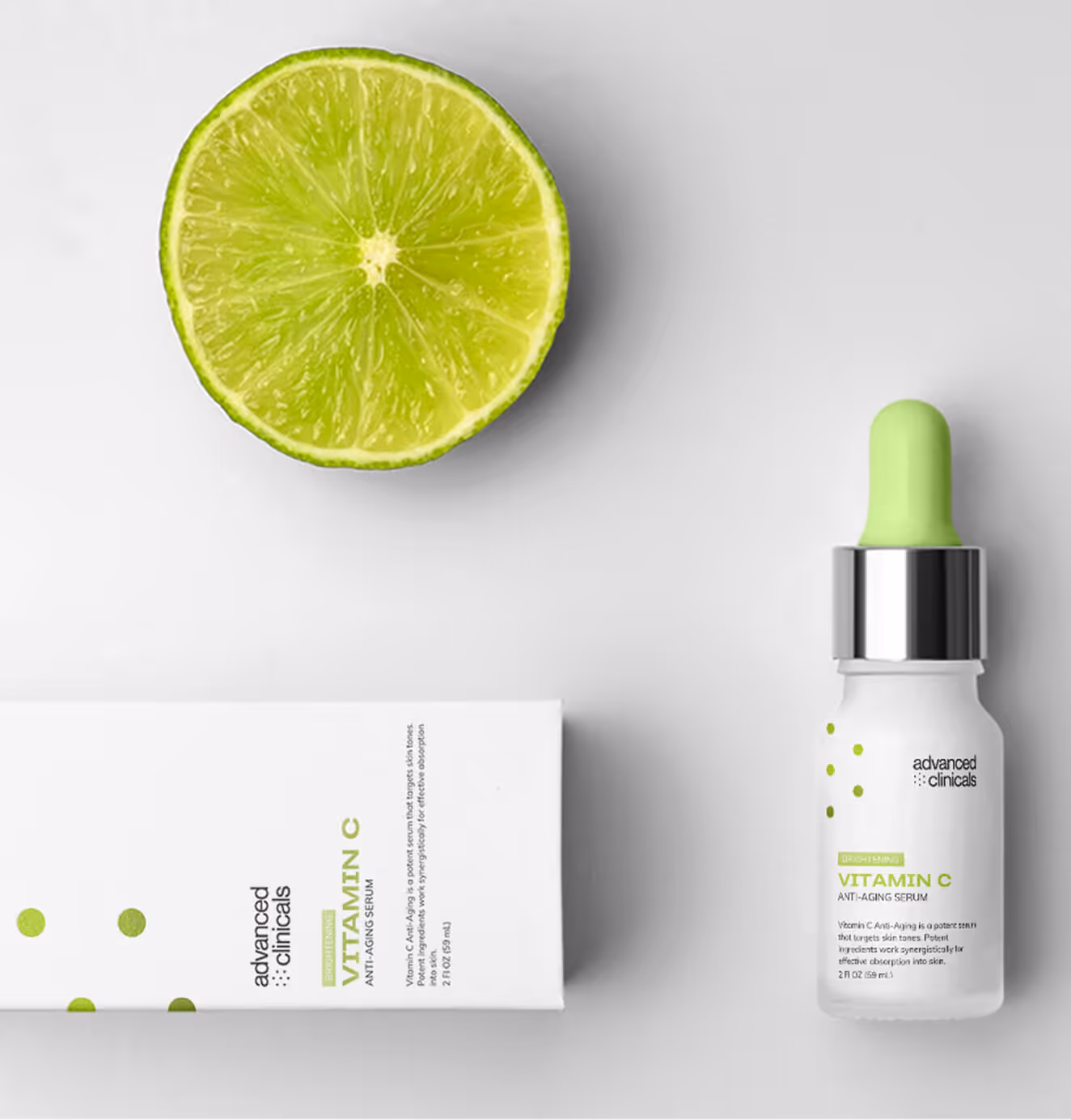 Product photo of Advanced Clinicals Vitamin C Anti-Aging Serum in white packaging with a lime green dropper, styled next to a lime slice.