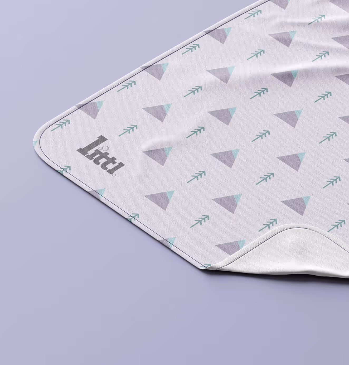 Soft children’s blanket featuring geometric pastel patterns and Littl brand logo, representing premium kids’ lifestyle product design.