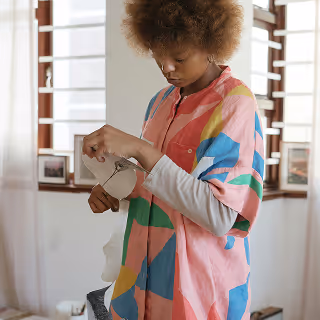 Woman writing on a whiteboard filled with brand health metrics and marketing diagrams.