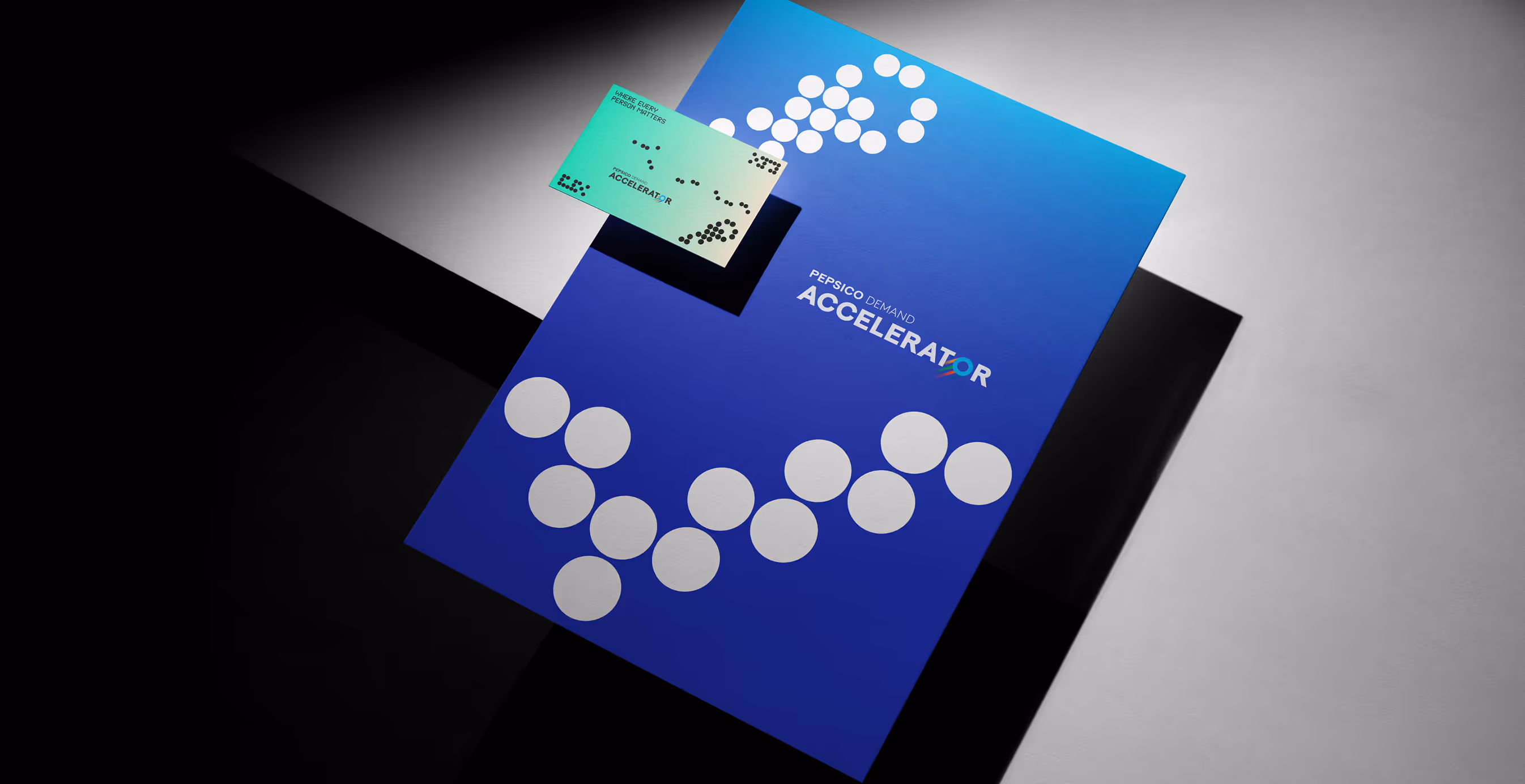 Pepsico Demand Accelerator brand folder and business card, both featuring bold white dot patterns against a gradient blue background, emphasizing a futuristic data-driven identity.