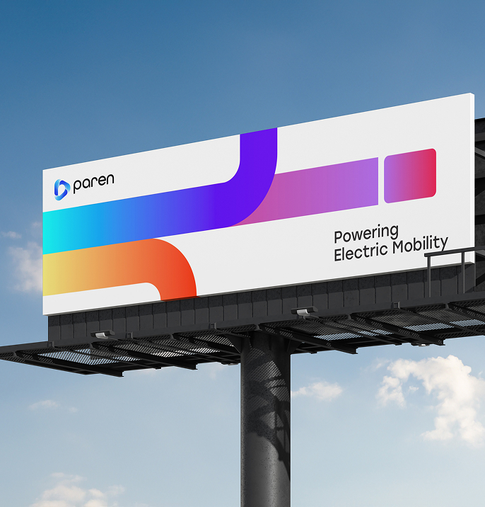 Large outdoor billboard with the Paren logo and colorful gradient design, featuring the tagline “Powering Electric Mobility” against a clear sky.
