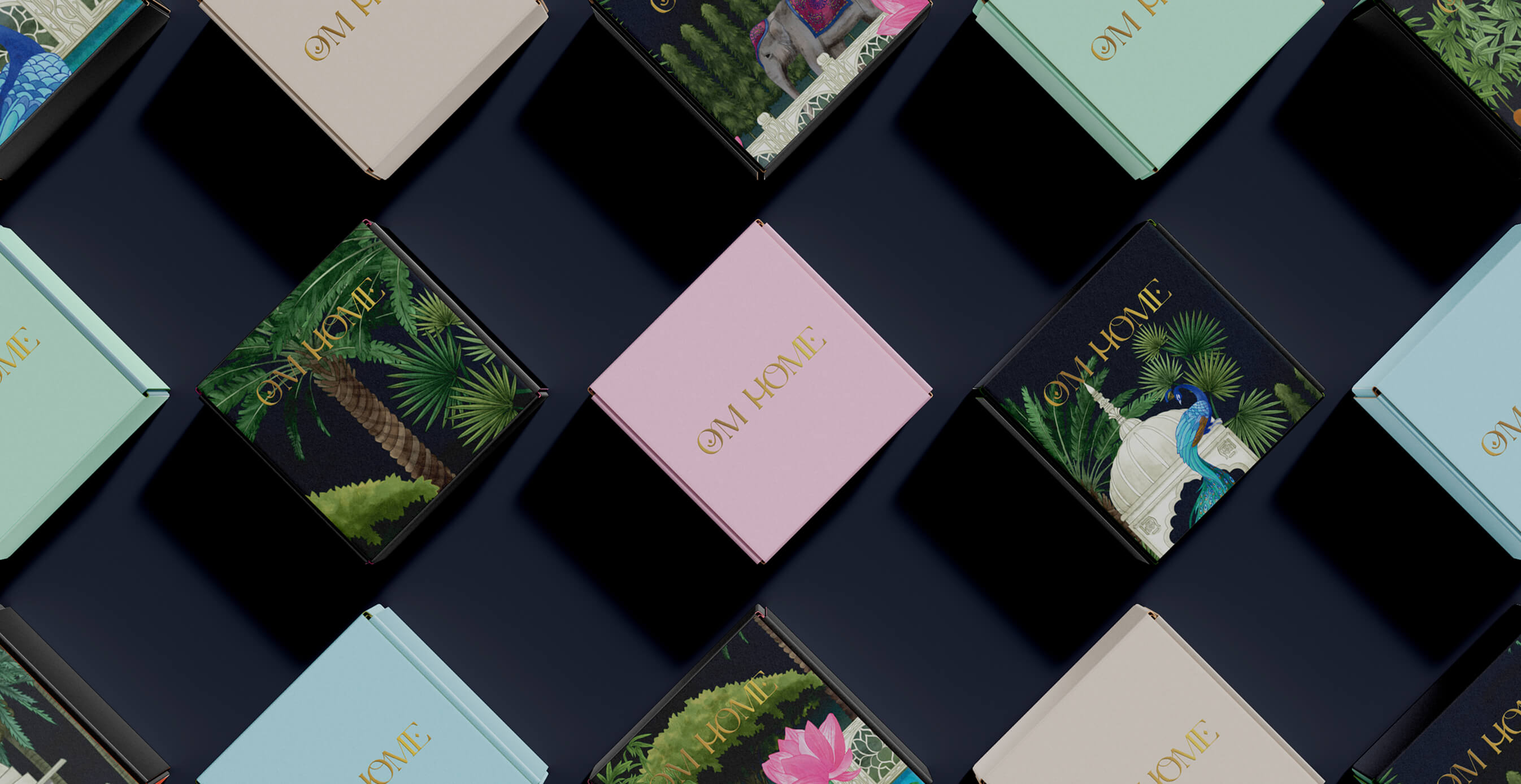 Flat lay of OM Home beauty product packaging in pastel and illustrated boxes, featuring gold lettering and South Asian-inspired designs.