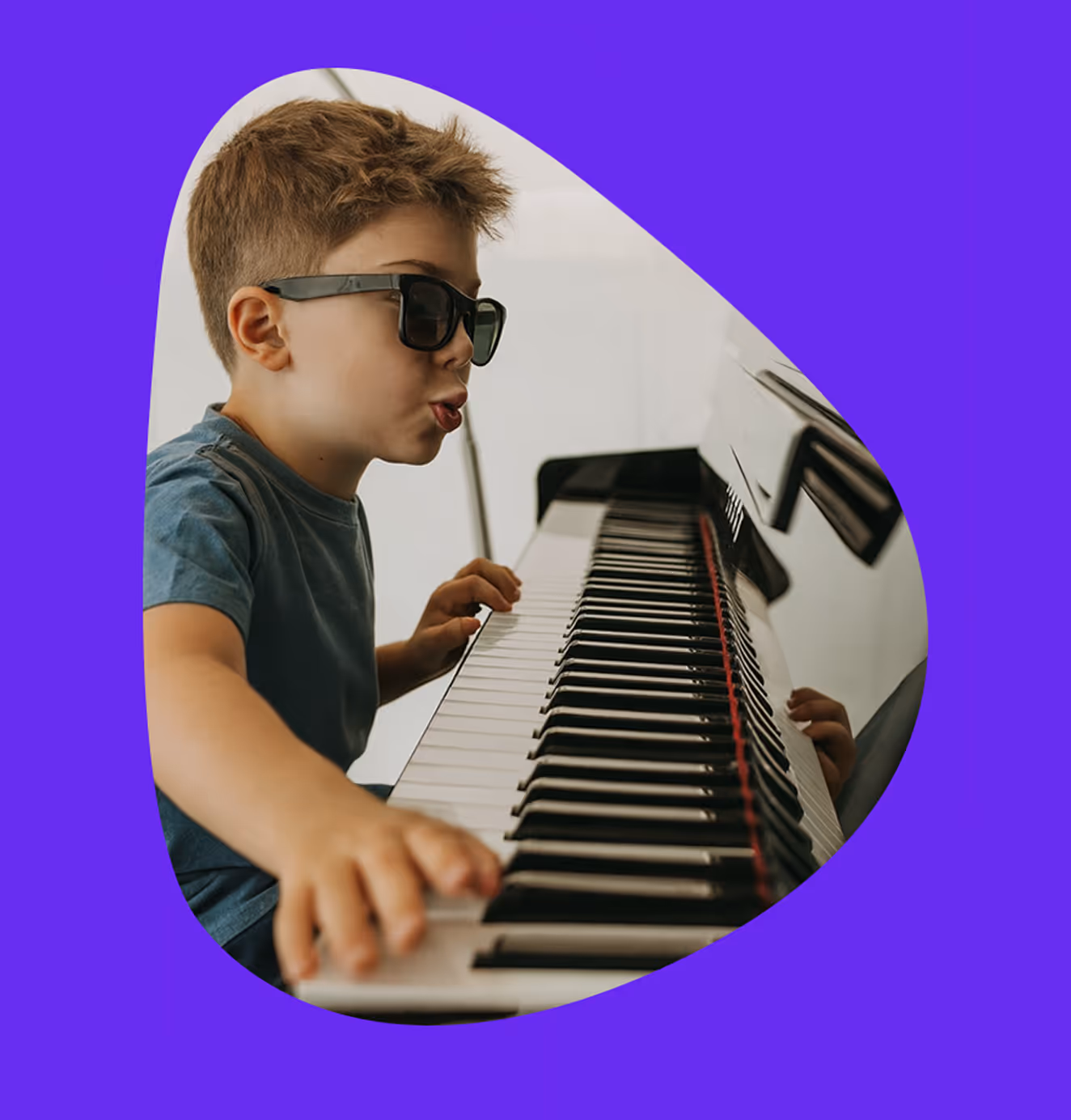 Child wearing sunglasses enthusiastically playing piano keys, set against a vibrant purple background.