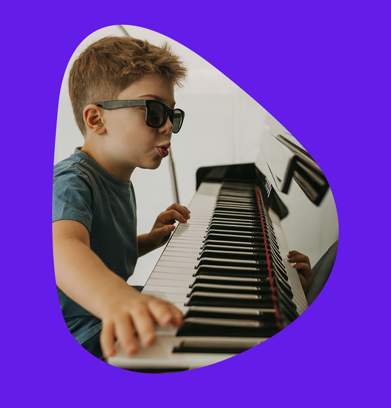 Child wearing sunglasses enthusiastically playing piano keys, set against a vibrant purple background.