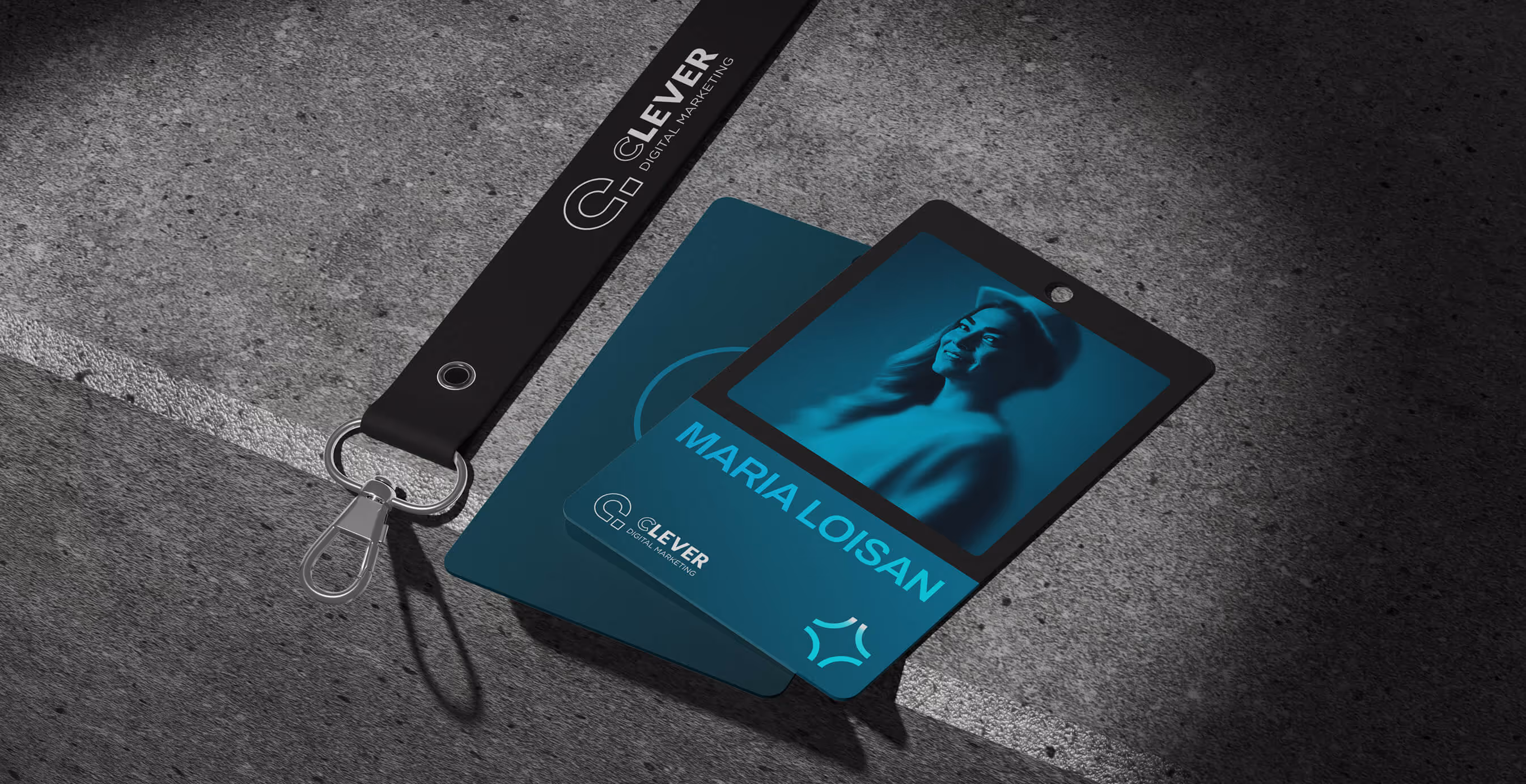 A branded Clever Digital lanyard and employee ID card for Maria Loisan displayed on a textured surface.