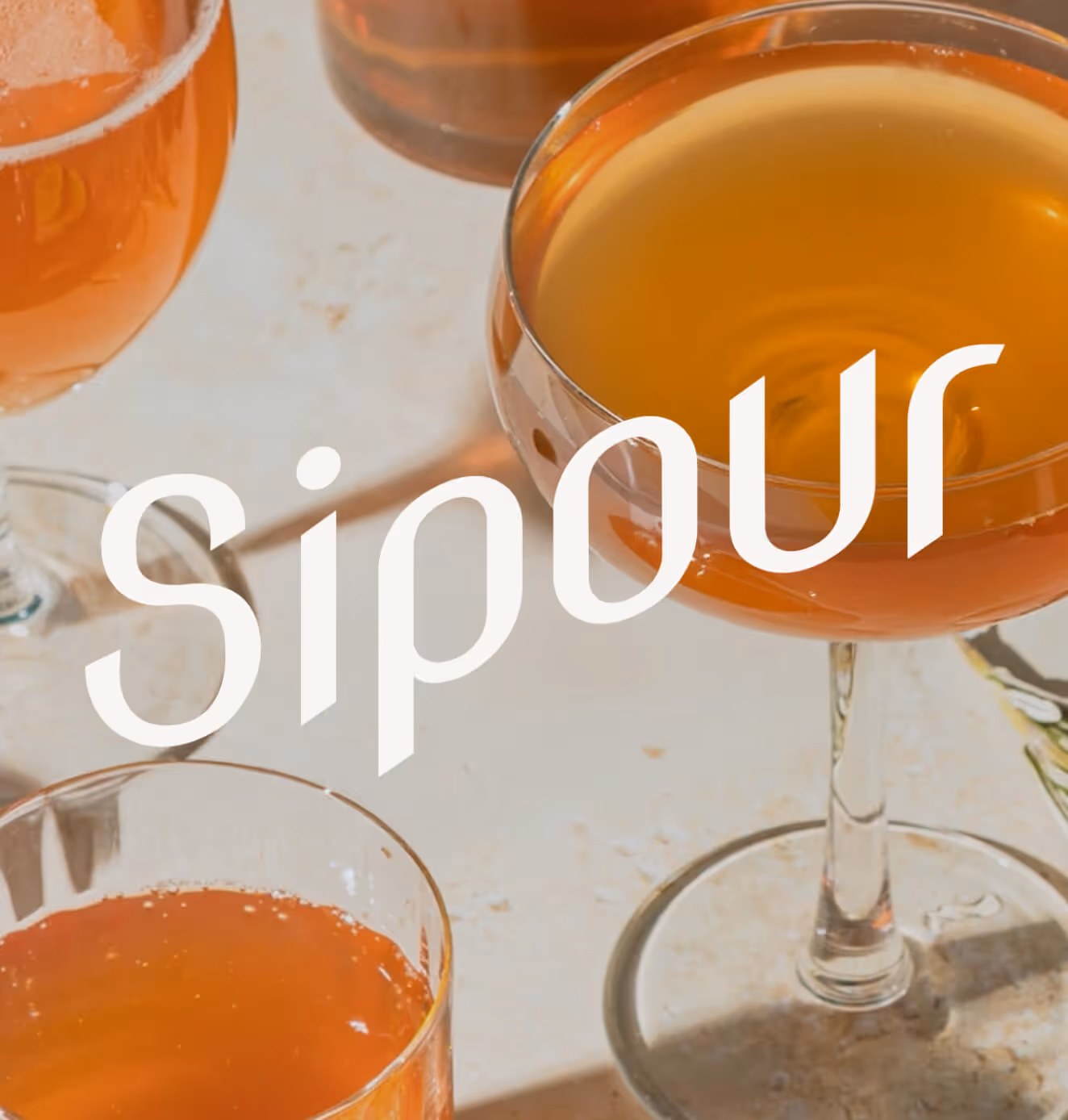 A variety of Sipour branded glassware filled with colorful cocktails, highlighting elegance and everyday magic.