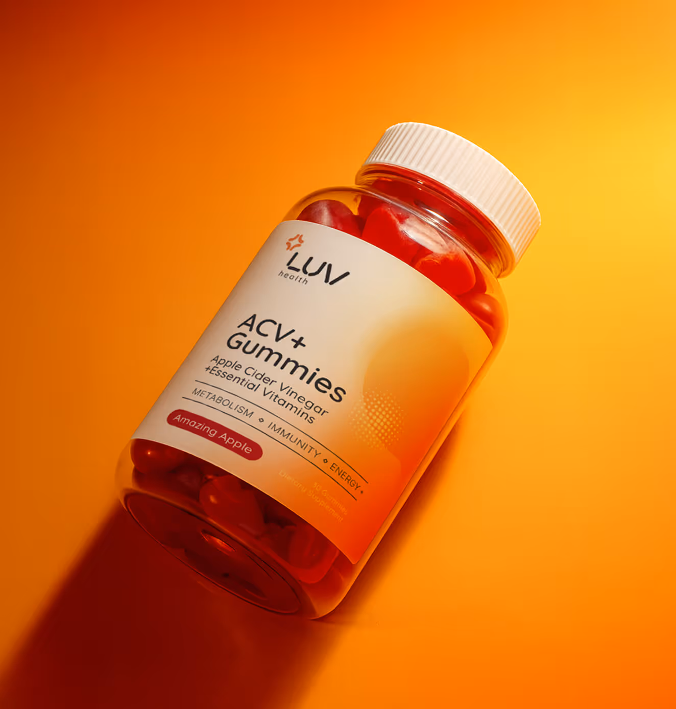 A jar of LUV Health ACV+ Gummies labeled “Apple Cider Vinegar + Essential Vitamins” placed on a vibrant orange-to-yellow gradient background.