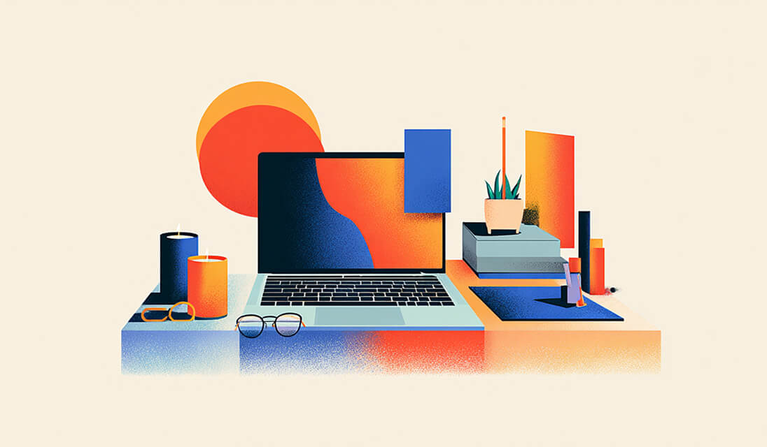 Laptop on a stylish desk surrounded by candles, glasses, and decor, symbolizing online store setup and brand aesthetic.