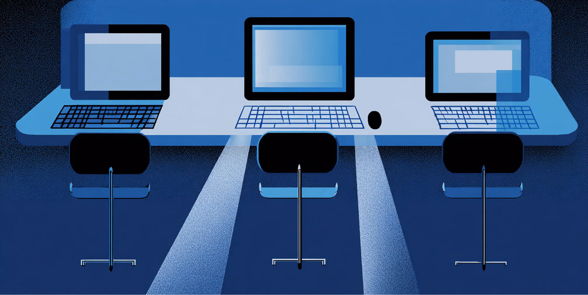 Row of computers on a long desk projecting light downward, symbolizing the design, development, and technical work behind building a Shopify website.