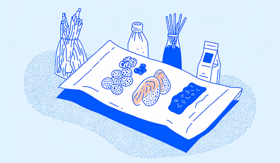 Flat-lay illustration of food ingredients arranged on paper, including bread, vegetables, bottles, and packaging.
