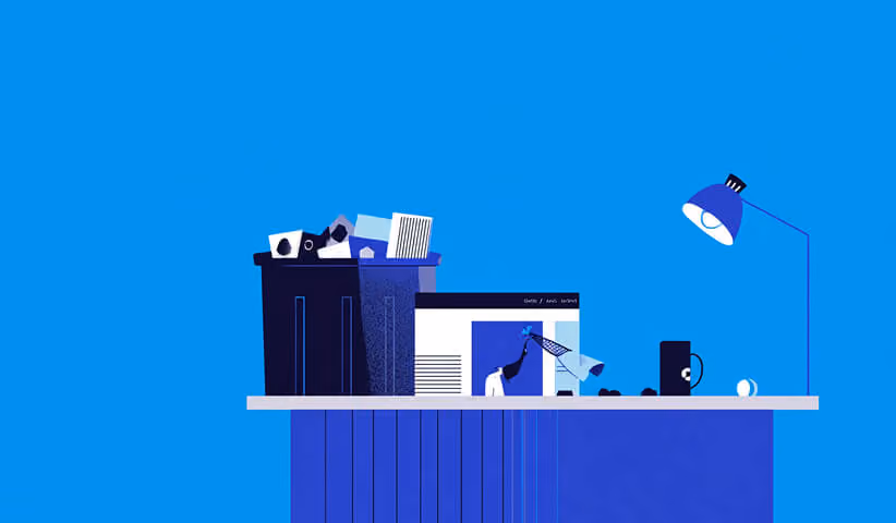 Minimal workspace with design assets and tools scattered on a desk, representing creative iteration during custom website builds.