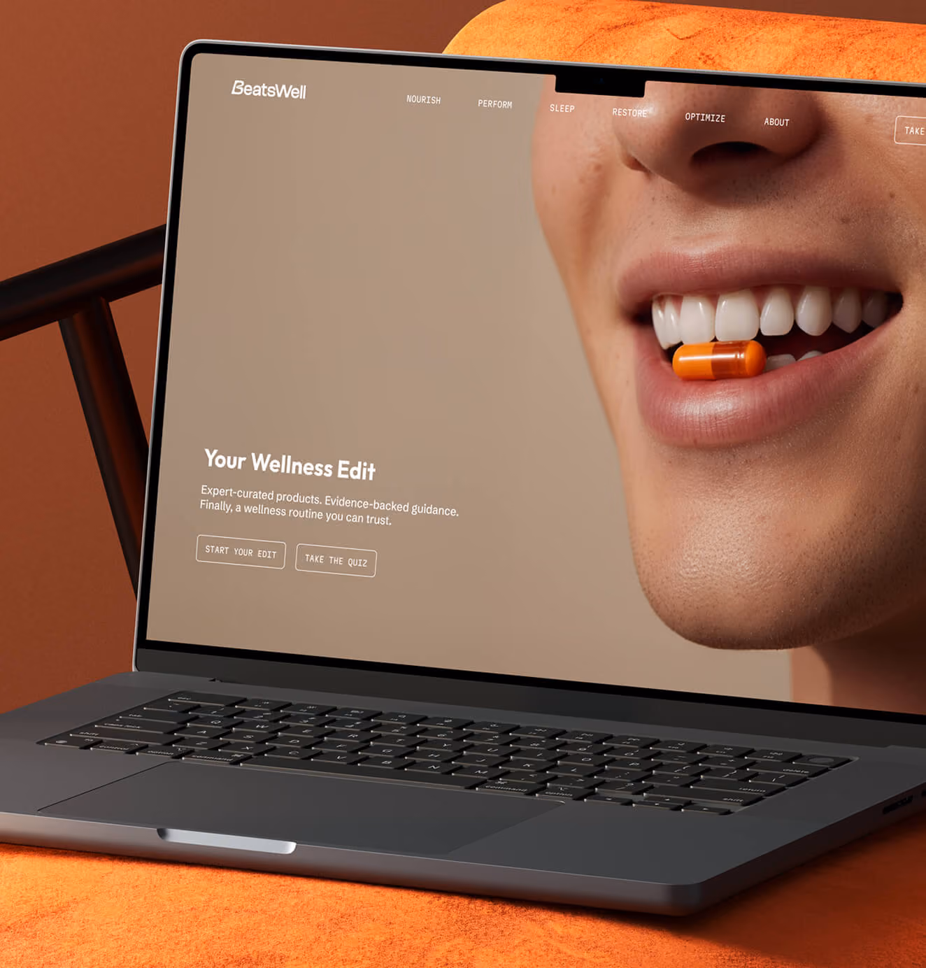 Laptop displaying the BeatsWell website featuring a close-up of a smiling mouth holding an orange supplement capsule and navigation for wellness categories.