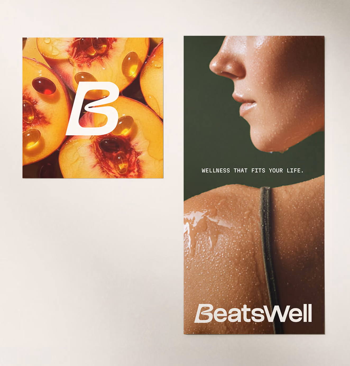 Two BeatsWell brand posters—one showing fruit with supplements and logo, the other a close-up of a person’s shoulder with the tagline “Wellness That Fits Your Life.”