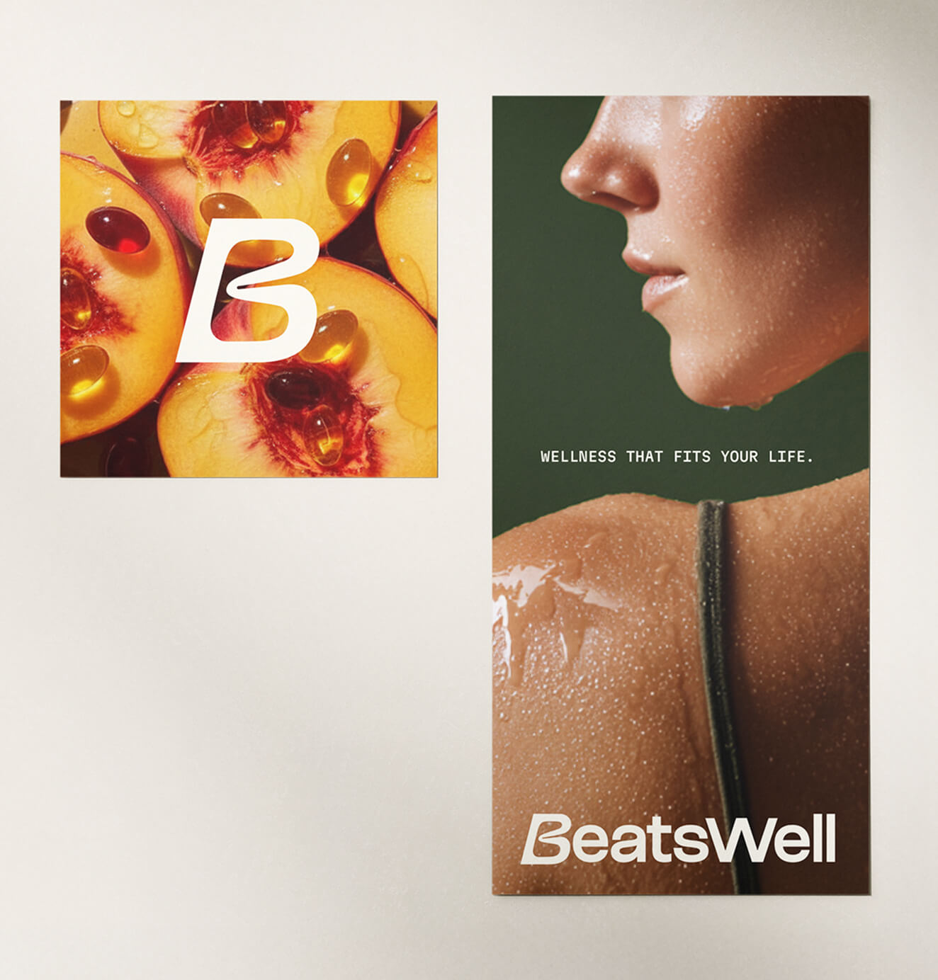 Two BeatsWell brand posters—one showing fruit with supplements and logo, the other a close-up of a person’s shoulder with the tagline “Wellness That Fits Your Life.”