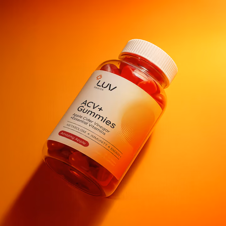 Bright orange product mockup of LUV Health ACV+ Gummies bottle on a vibrant gradient background, showcasing modern wellness packaging design.