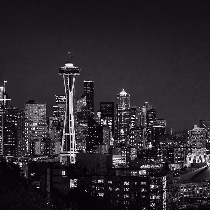 Black and white Seattle skyline at night featuring the Space Needle and downtown skyscrapers in Washington State.