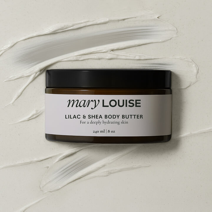 Luxury skincare product jar of Mary Louise Lilac and Shea Body Butter placed on a textured cream background.