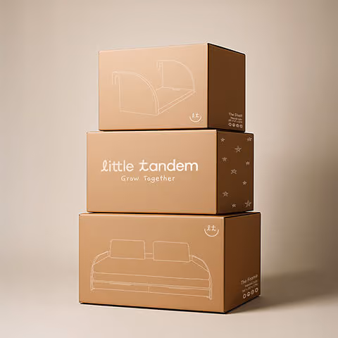 Stacked kraft shipping boxes branded “little tandem – Grow Together” with simple line illustrations of children’s furniture.