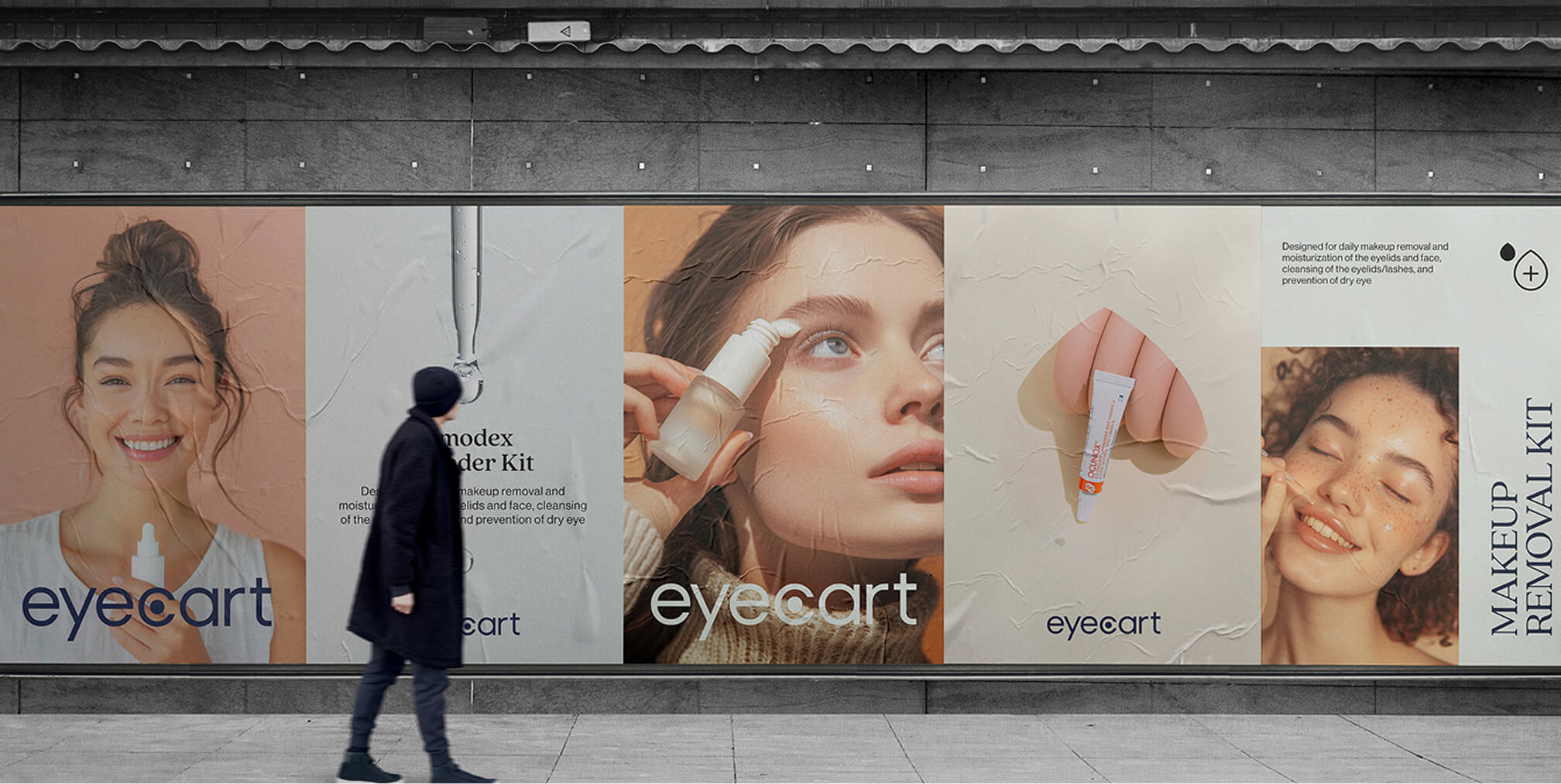 Large Eyecart billboard advertisement featuring skincare product visuals and a pedestrian walking past.