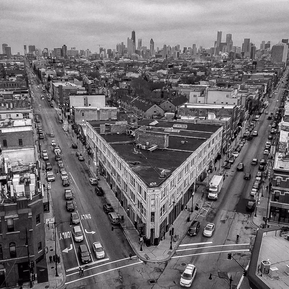 Aerial view of Chicago neighborhood streets leading toward the downtown skyline in Illinois.