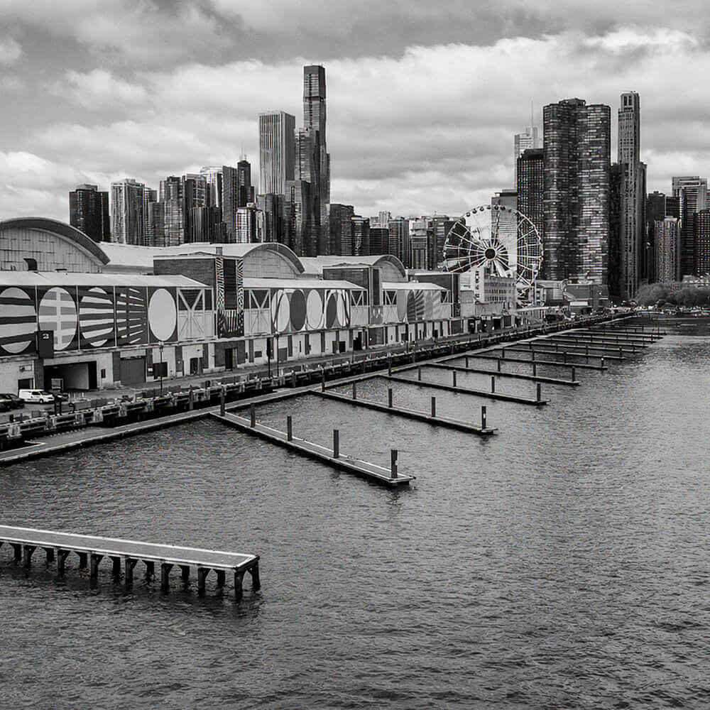 Chicago Navy Pier waterfront with skyline, Ferris wheel, and Lake Michigan in the background.
