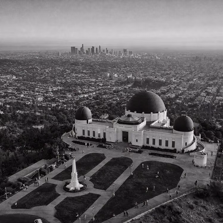 Griffith Observatory overlooking Los Angeles skyline and sprawling cityscape in California.