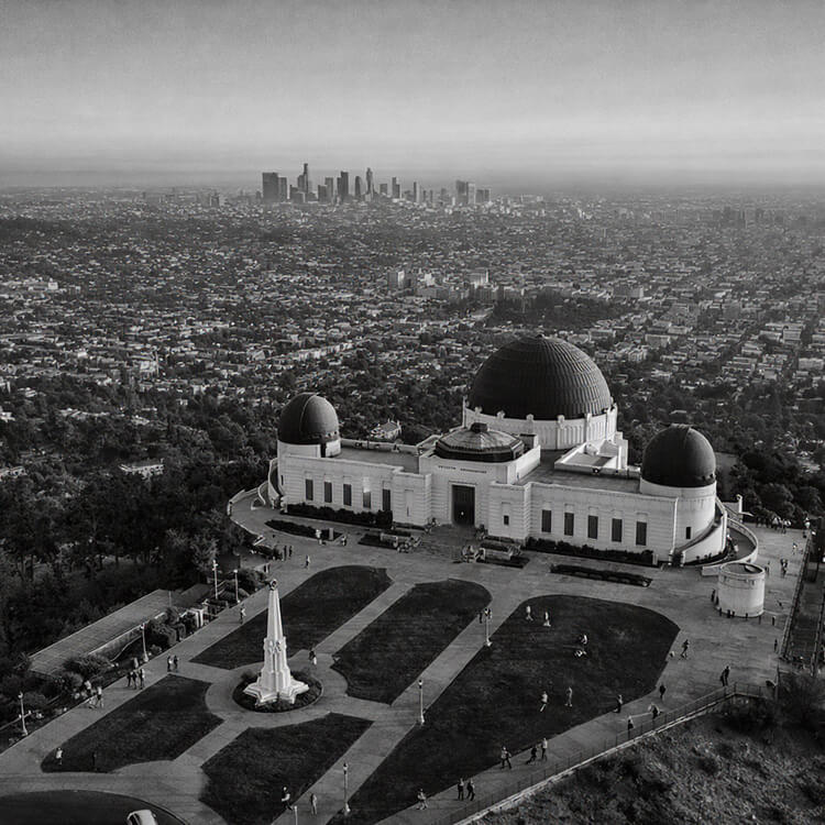 Griffith Observatory overlooking Los Angeles skyline and sprawling cityscape in California.
