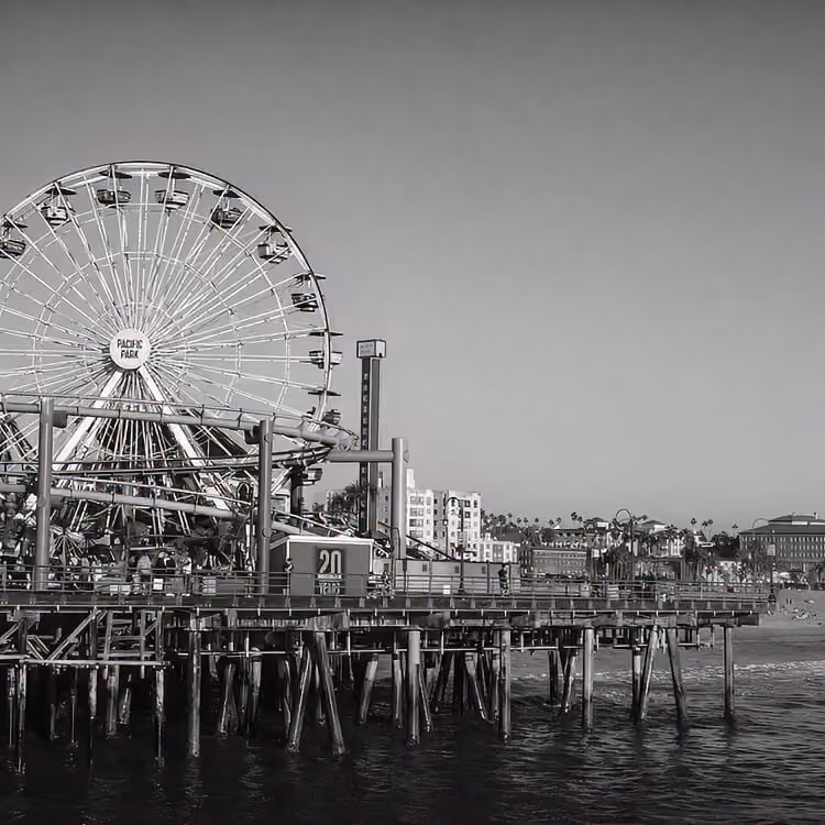 Santa Monica Pier Ferris wheel and boardwalk extending over the Pacific Ocean in Los Angeles County.