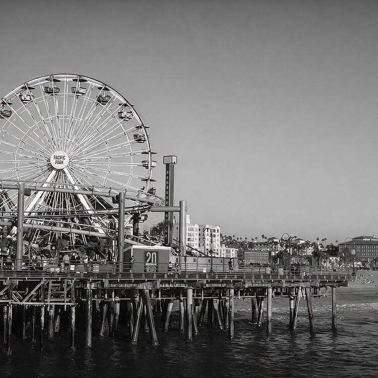 Santa Monica Pier Ferris wheel and boardwalk extending over the Pacific Ocean in Los Angeles County.